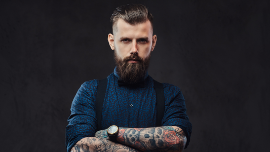 A man with a beard and tattoos.