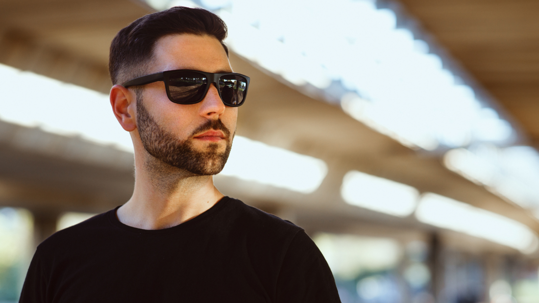 A man with a short beard style wearing dark sunglasses.