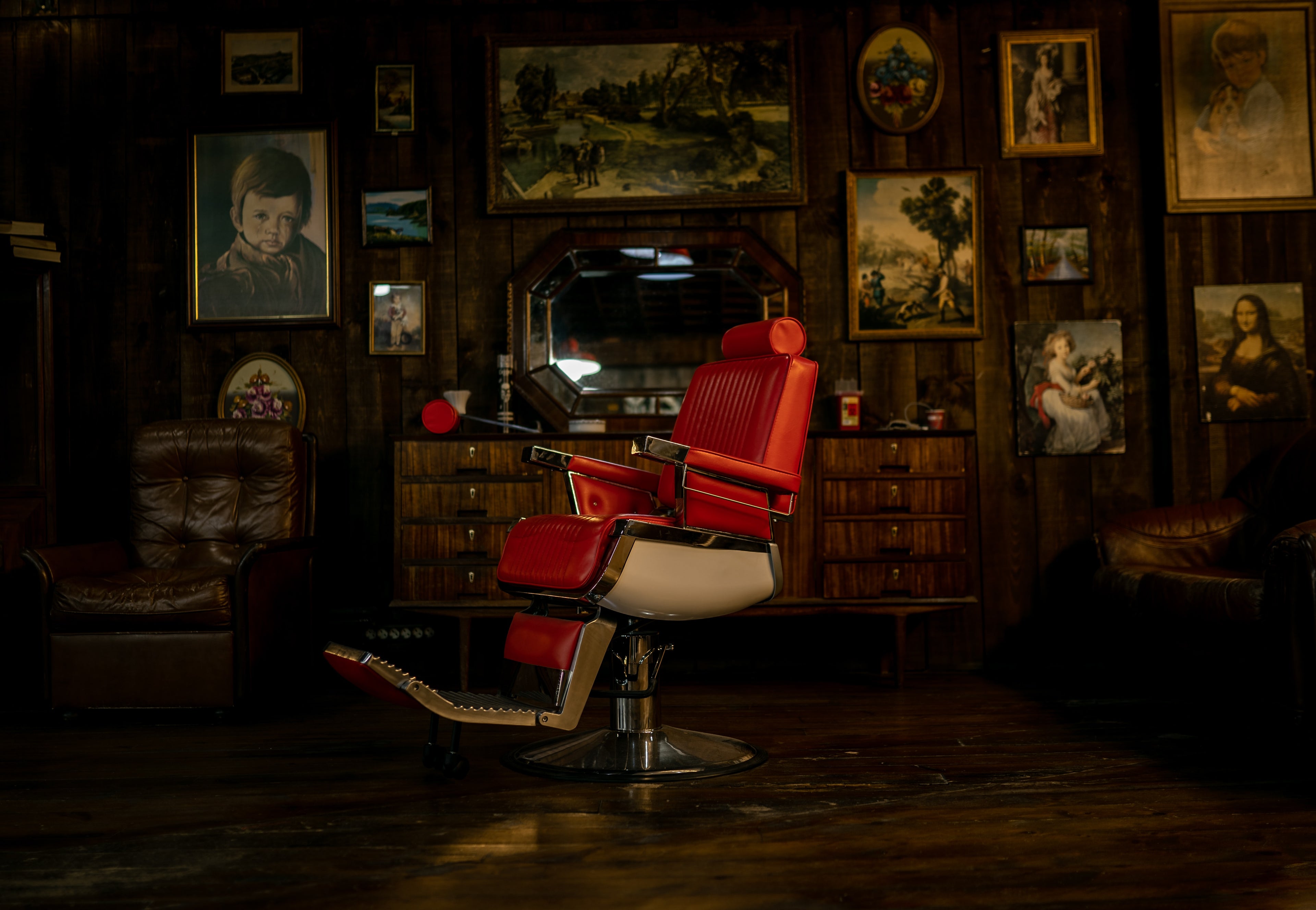 Vintage leather red barber chair in a rustic barbershop